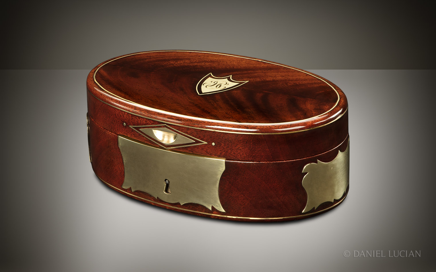 Front right view of the closed miniature French jewellery box in Cuban mahogany with brass mounts.