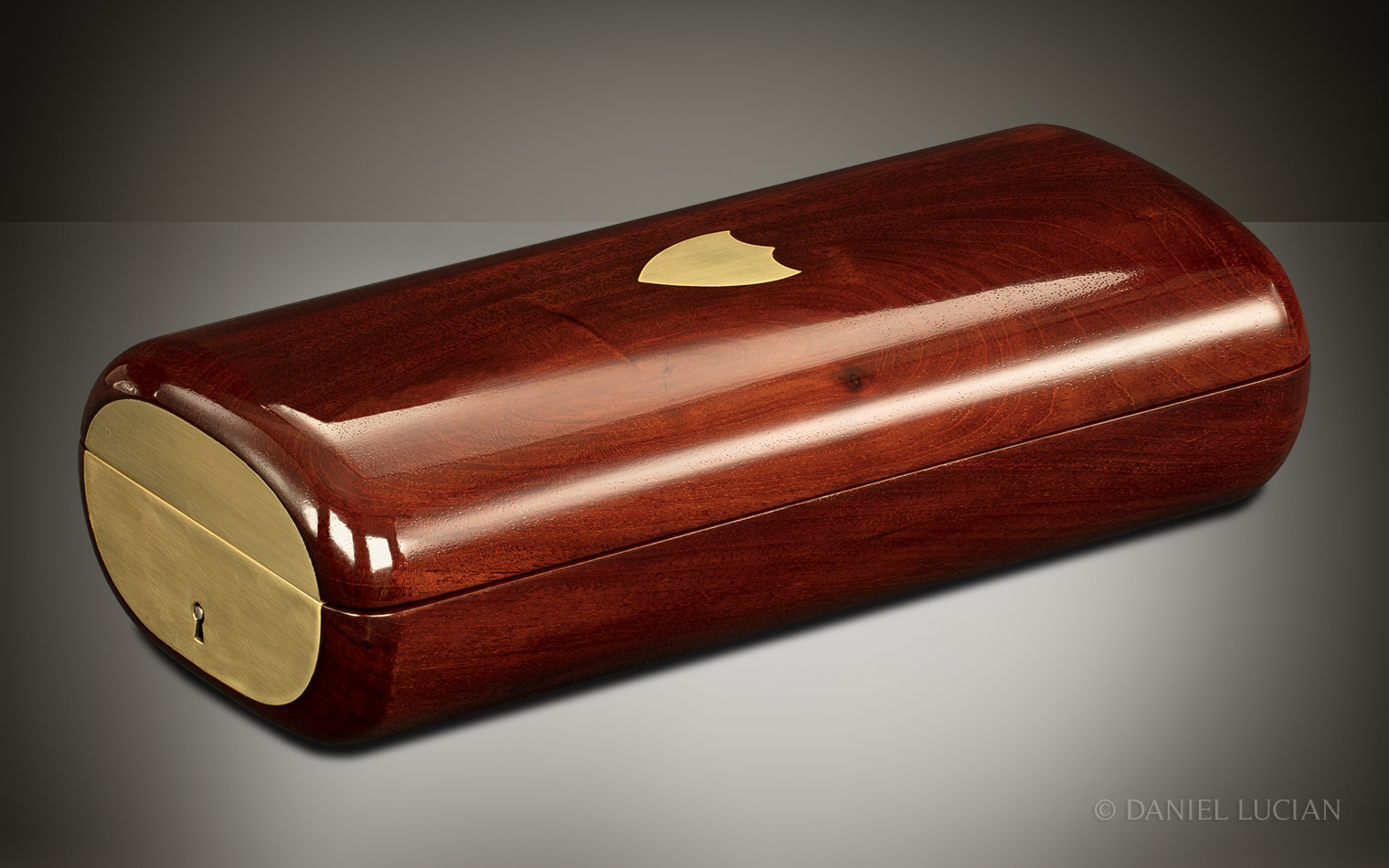 Front right view of the closed French travelling jewellery box in Cuban mahogany with brass end plate.