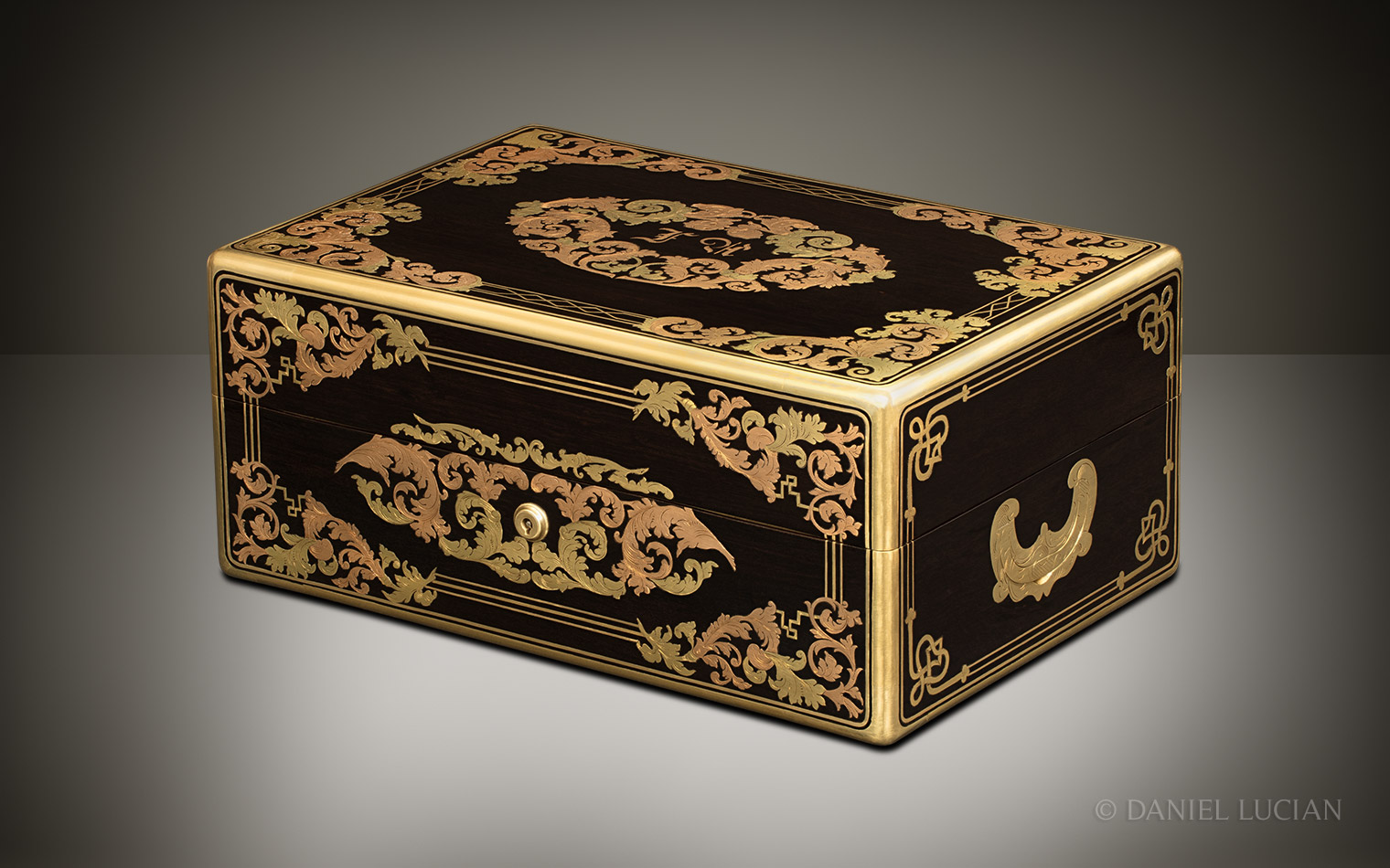 Front right view of the closed French ebony jewellery box with yellow and rose brass inlay.