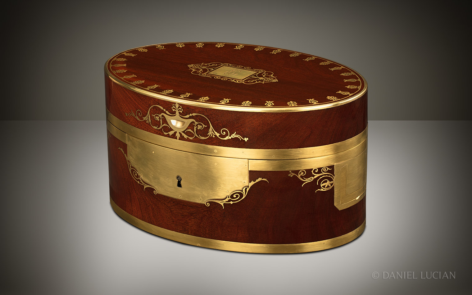 Front right view of the closed oval Cuban mahogany jewellery box.